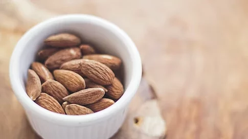 Almond nut in white round bowl, ketosis food
